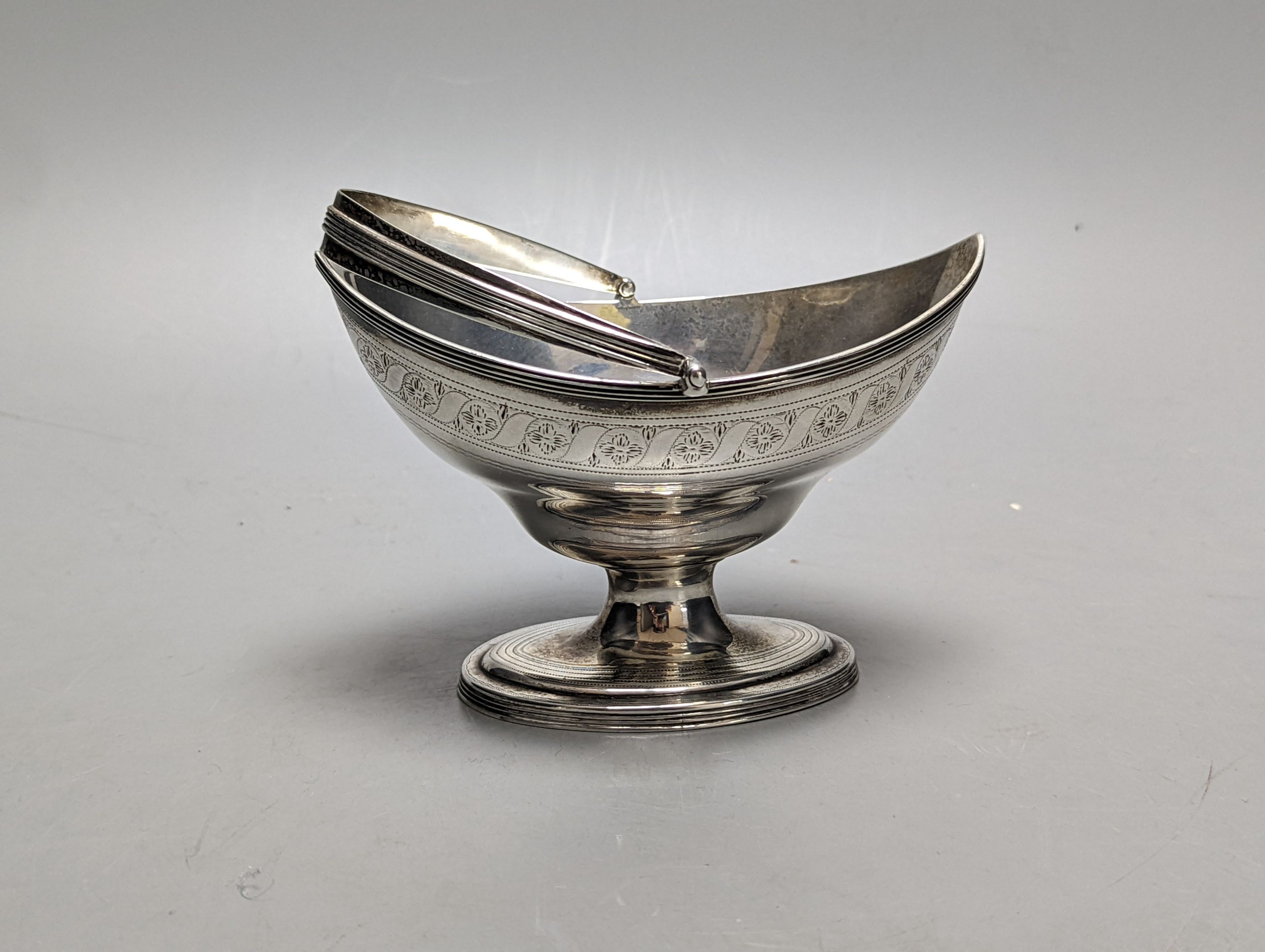 A George III silver boat shaped sugar basket by Peter & Ann Bateman, London, 1799, length 13.9cm, 5oz.